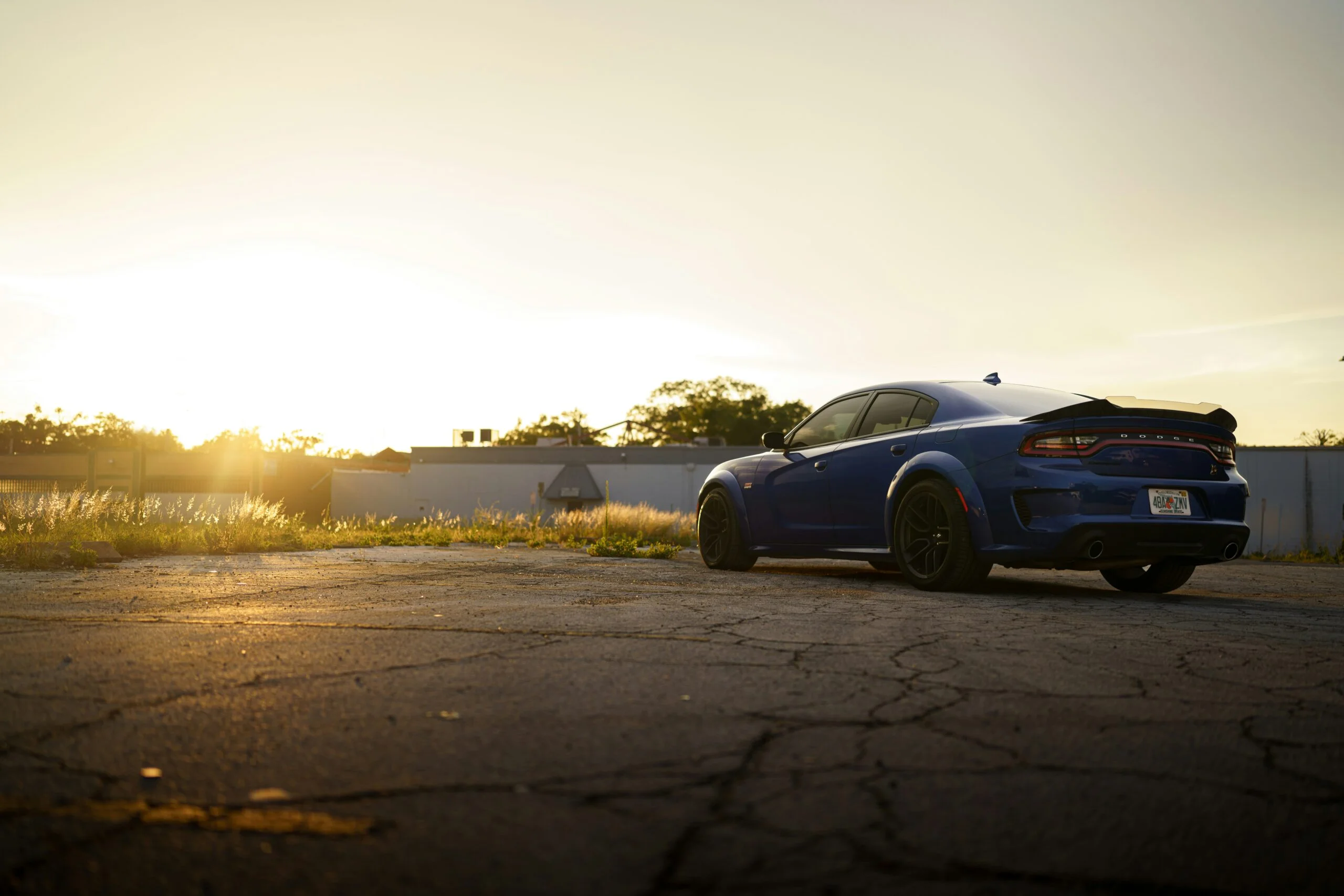 a-blue-car-parked-on-a-road-scaled